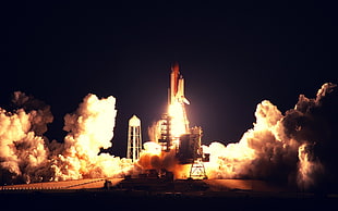 space shuttle taking off during nighttime