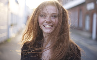 woman wearing black shirt smiling close-up photography