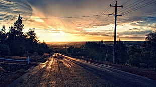 black pavement road, sunset, power lines, road, sky