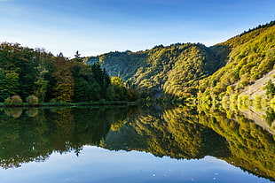 lake surrounded by green hills