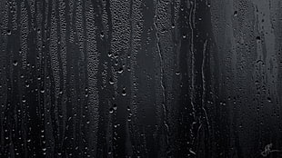 black painted wall with water droplets