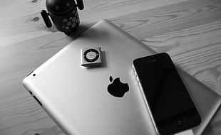 silver iPad, iPod shuffle on gray surface