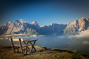 bench and table on hill with another hill view in front at daytime HD wallpaper