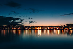 landscape photo of city beside body of water at night