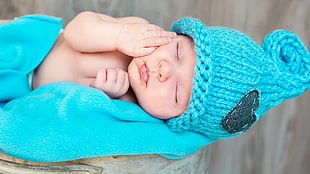 teal and white knitted textile, baby, woolly hat