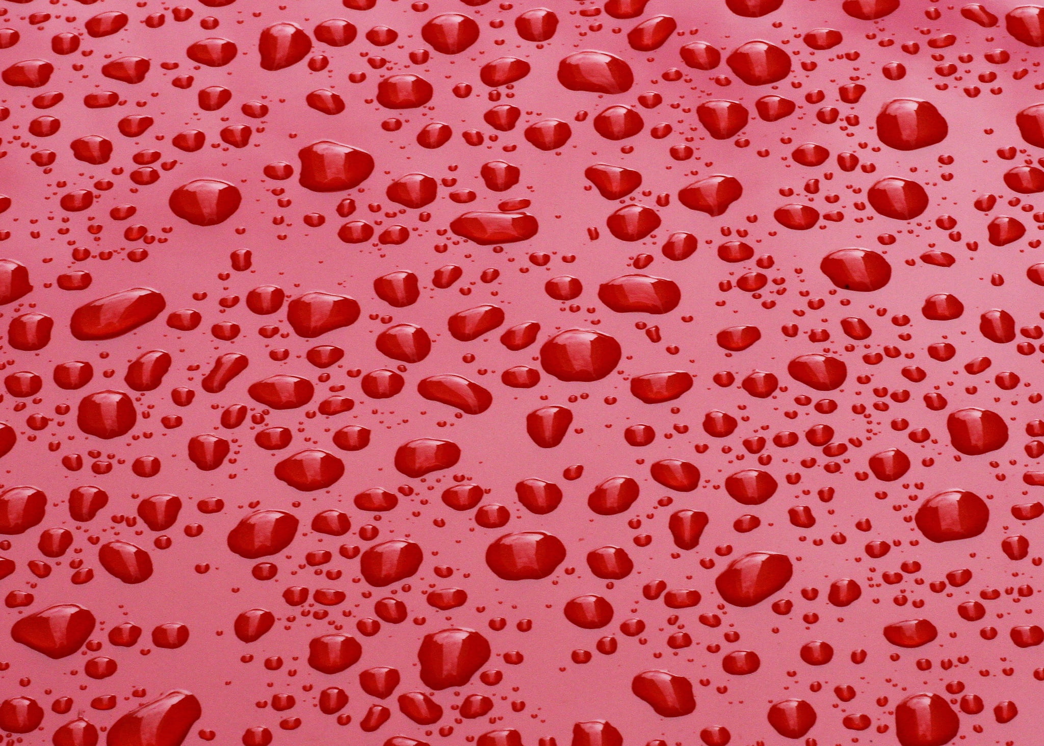 red surface with water droplets