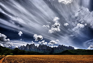 landscape photo of mountain under cloudy sky during daytime, montserrat