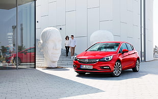 red Opel Astra hatchback during daytime HD wallpaper