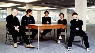 photo of 5 men sitting near table