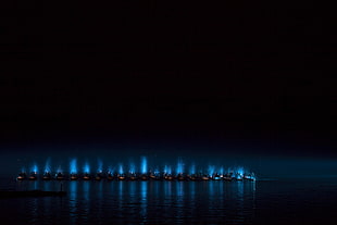 boats line on water with blue lights HD wallpaper