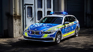 photo of blue and green Police car