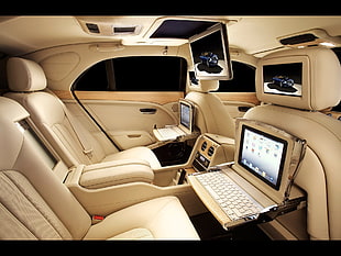 two white laptop computers, car