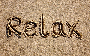 Relax text on beach sand
