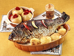 cooked fish on oval brown ceramic platter