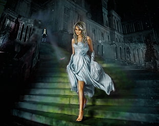 woman wearing blue dress walked on stair