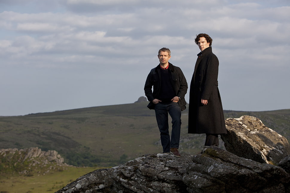 two man in black suit standing on brown rock HD wallpaper