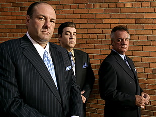 three men wearing formal coat