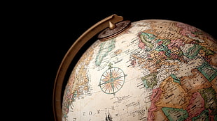 close-up of a desk globe against black background