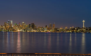 calm water with overlooking of high rise building at night time, lake union
