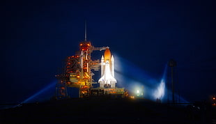 white and orange rocket lift off during night time HD wallpaper