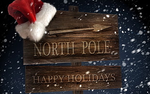 brown North Pole happy holidays signage