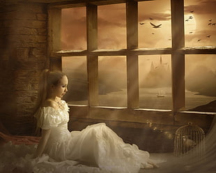 woman in white dress near window pane