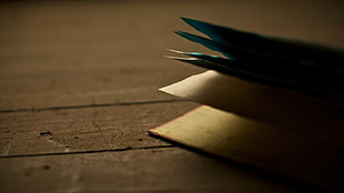photo of book on brown surface, wooden surface, books, shadow, depth of field