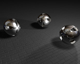 gray scale photo of three balls