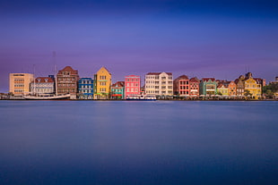 photo of multicolored building surrounded by body of water, willemstad, curacao