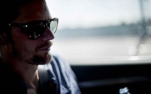 man in black sunglasses sitting inside car during daytime