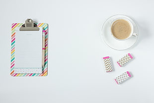 clipboard near cup of coffee and erasers HD wallpaper