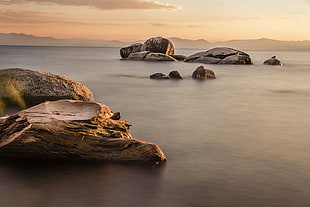 rock formations on body of water during sunset, lake tahoe