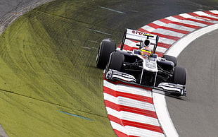 white and black formula 1 on race track HD wallpaper