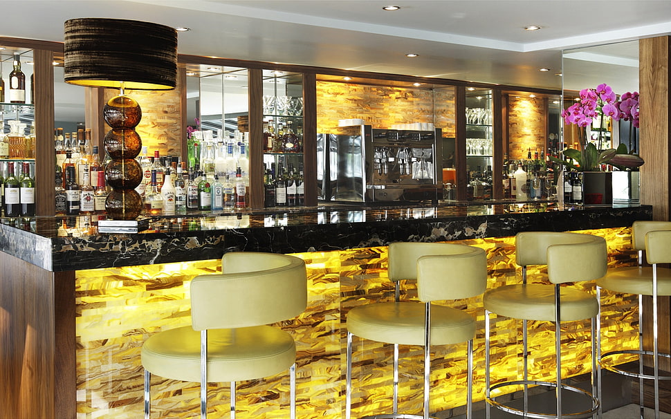 four yellow bar stool chairs near bar HD wallpaper