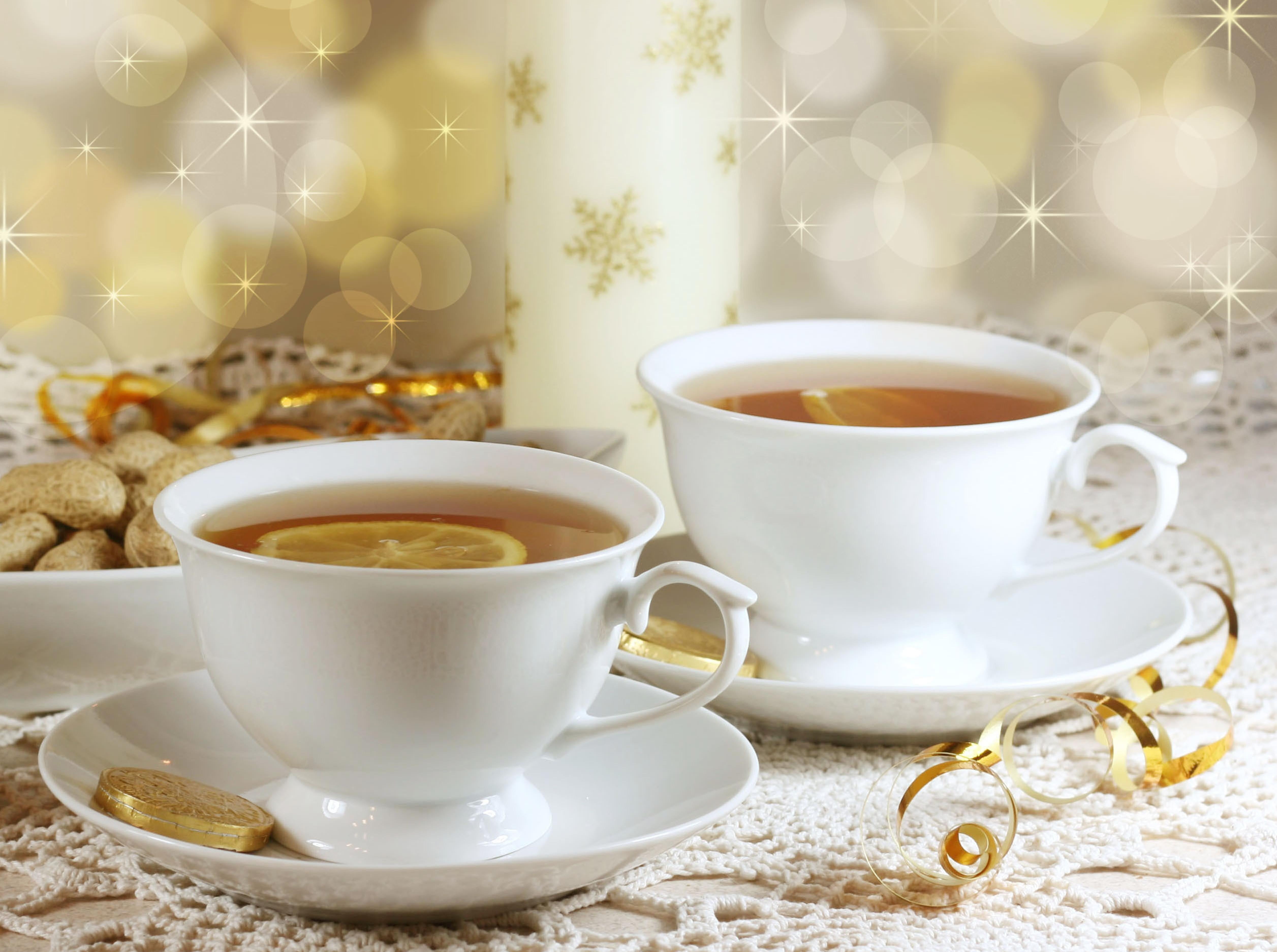 two white ceramic teacup on top of saucers