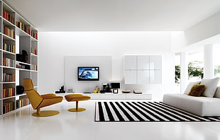 white and black striped area rug and whit leather couch and throw pillows