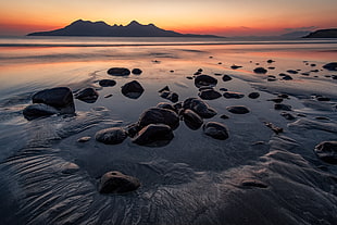 sea with rocks during sunset