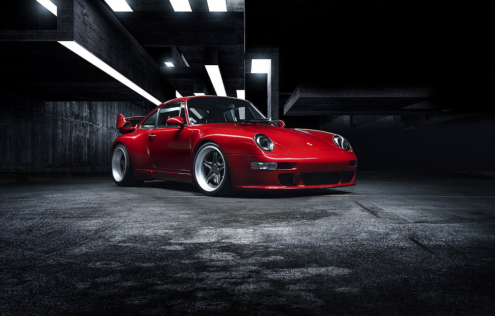 red Porsche sports coupe on concrete road HD wallpaper