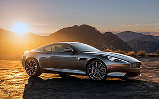 gray Aston Martin DB9 parked on dirt road during daytime HD wallpaper