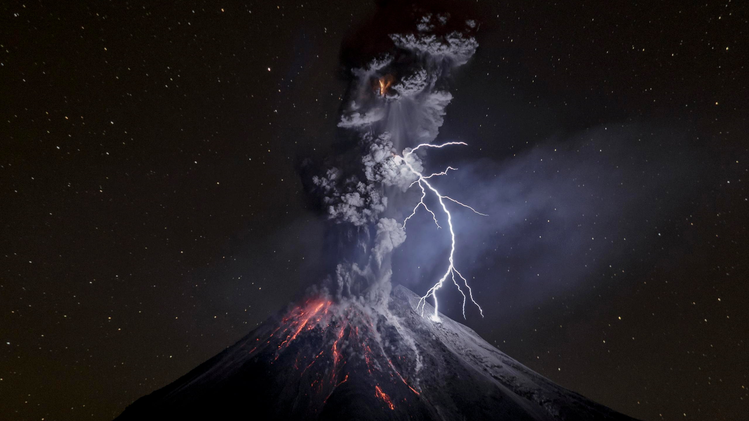 erupting volcano at night