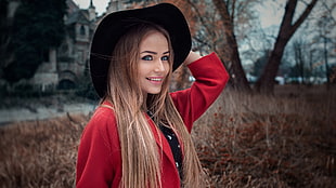 woman in red blazer and black cowboy hat