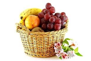 fruits on wicker basket beside flowers HD wallpaper
