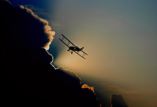 airplane flying during sunrise