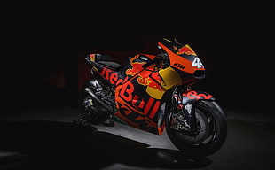 black red, and yellow Red Bull sports bike