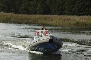 woman on gray speed boat