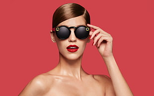 woman with black sunglasses with red backghround