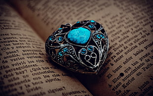 selective focus photography of heart-cut turquoise ring