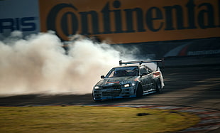 smoke behind race car on track