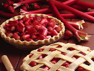 still life photography of strawberry pies