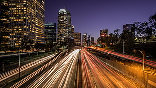 view of buildings with road during night time, highway 110, los angeles